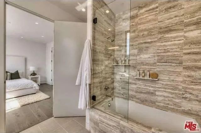 A bathroom with a bathtub and a walk in shower