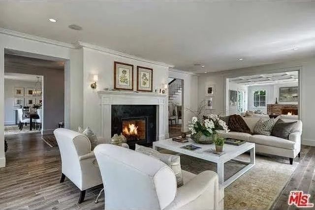 A living room filled with furniture and a fireplace