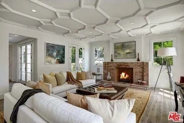 A living room with a fireplace and a white couch