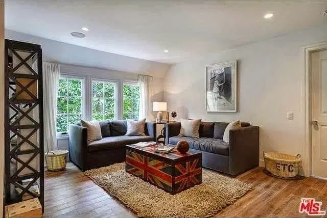 A living room with two couches, a coffee table, and a rug