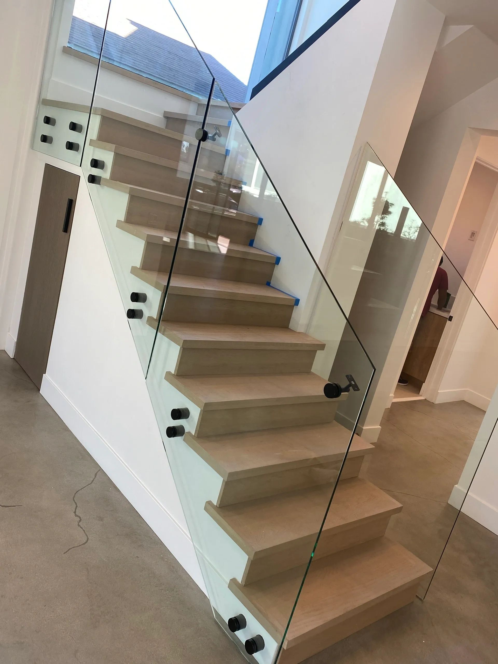 A staircase with a glass railing in a house