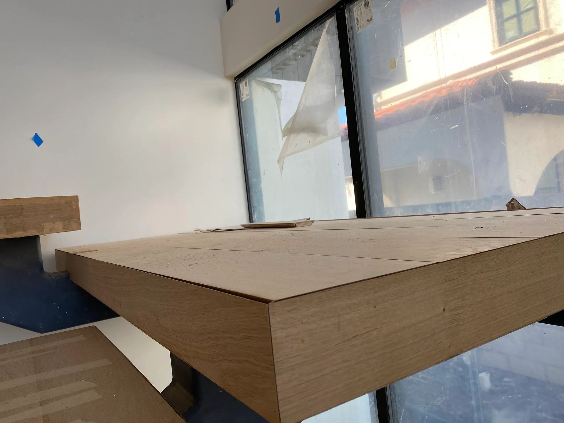 A piece of cardboard is sitting on a table in front of a window