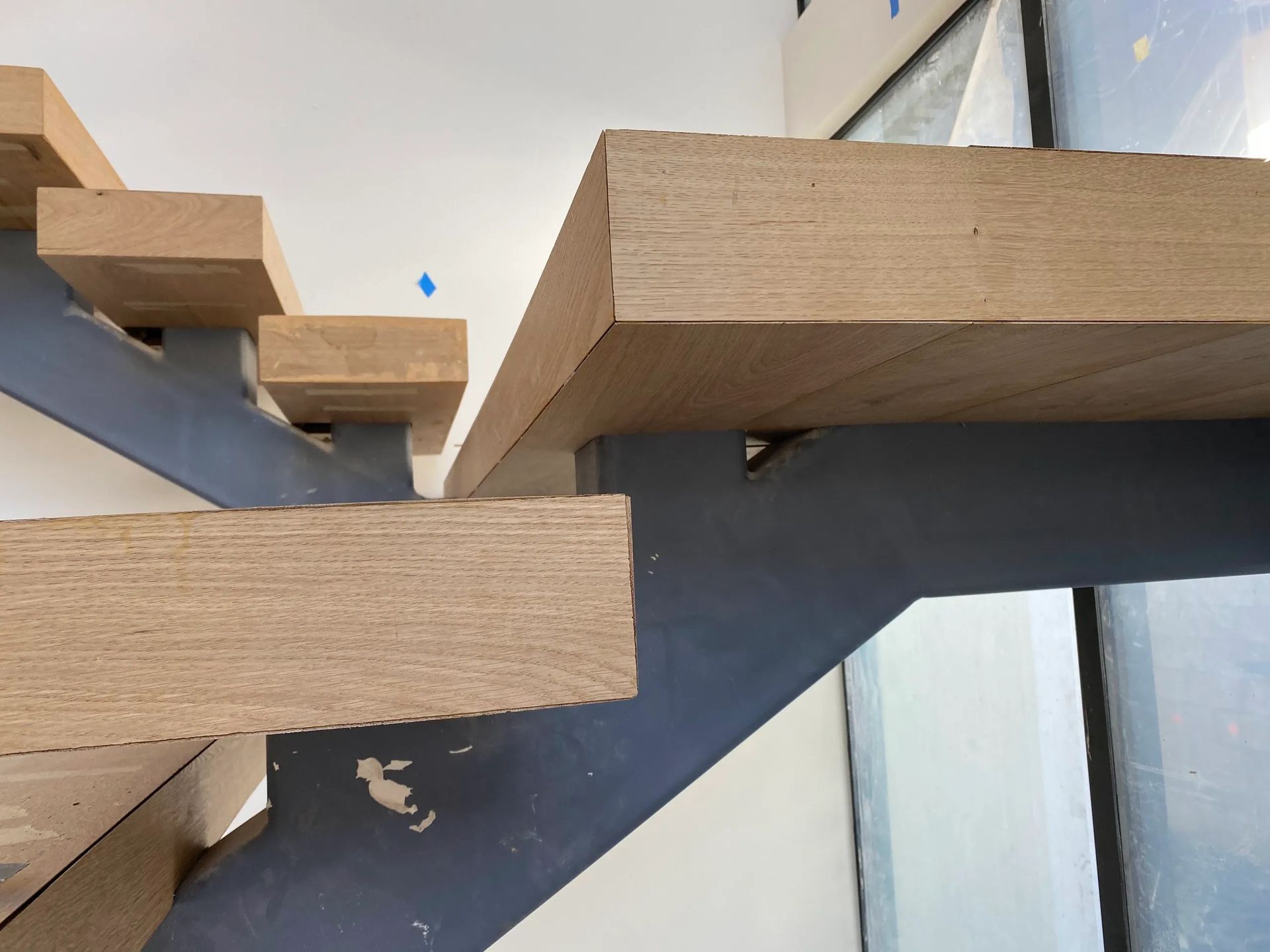 A close up of a wooden staircase with a metal frame