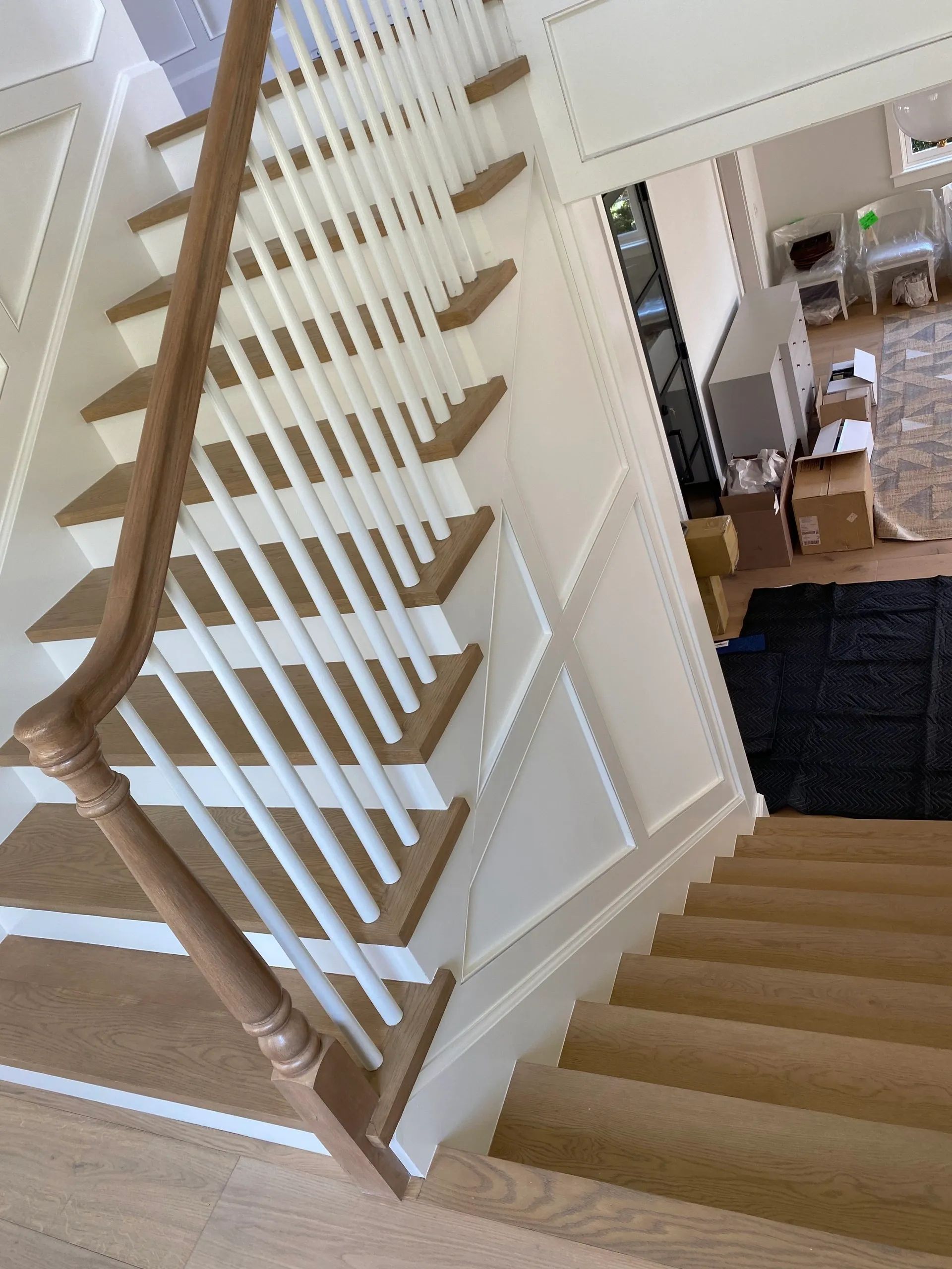A staircase with white railings and wooden steps