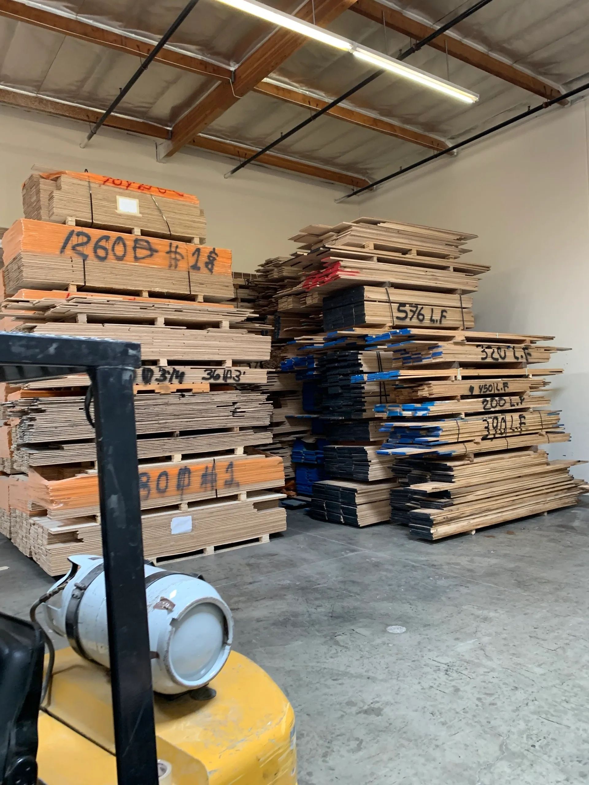 A warehouse filled with lots of wooden pallets and boxes