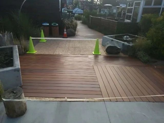 A wooden deck with yellow cones on it