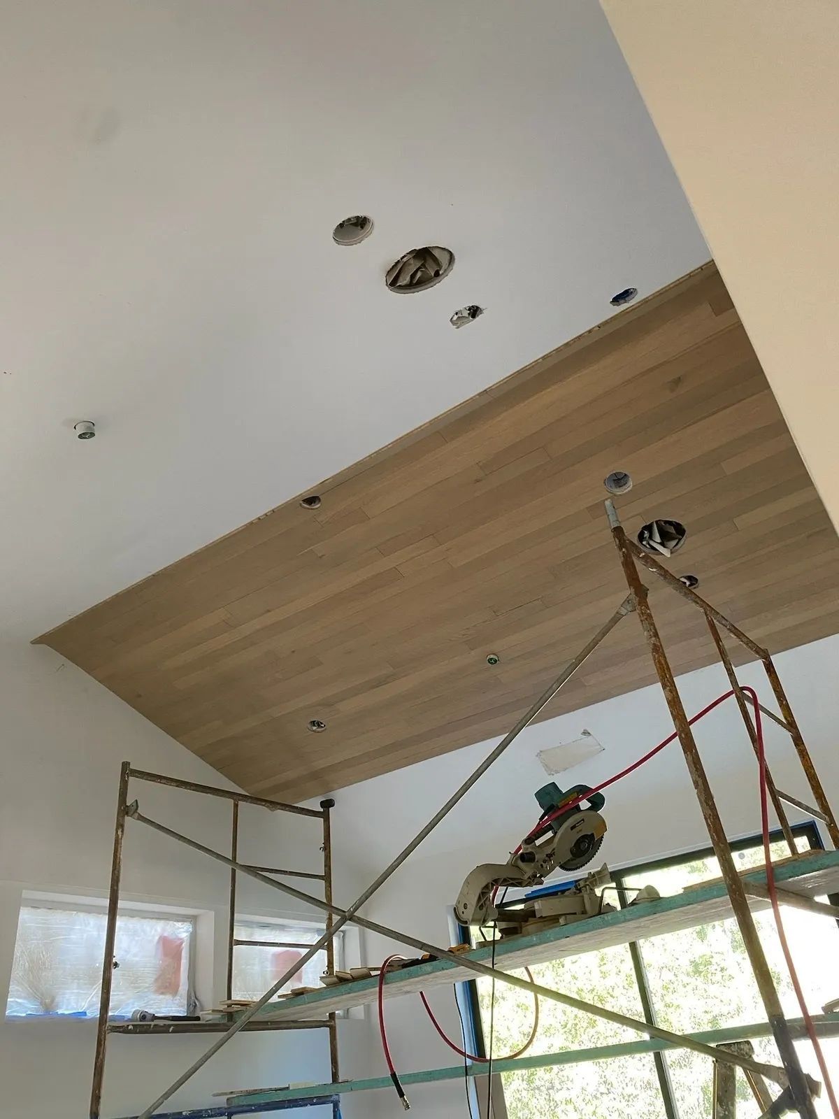 A room with a wooden ceiling and a scaffolding