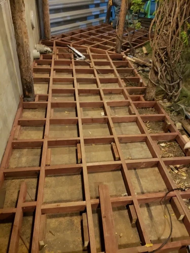 A wooden floor is being built in a room