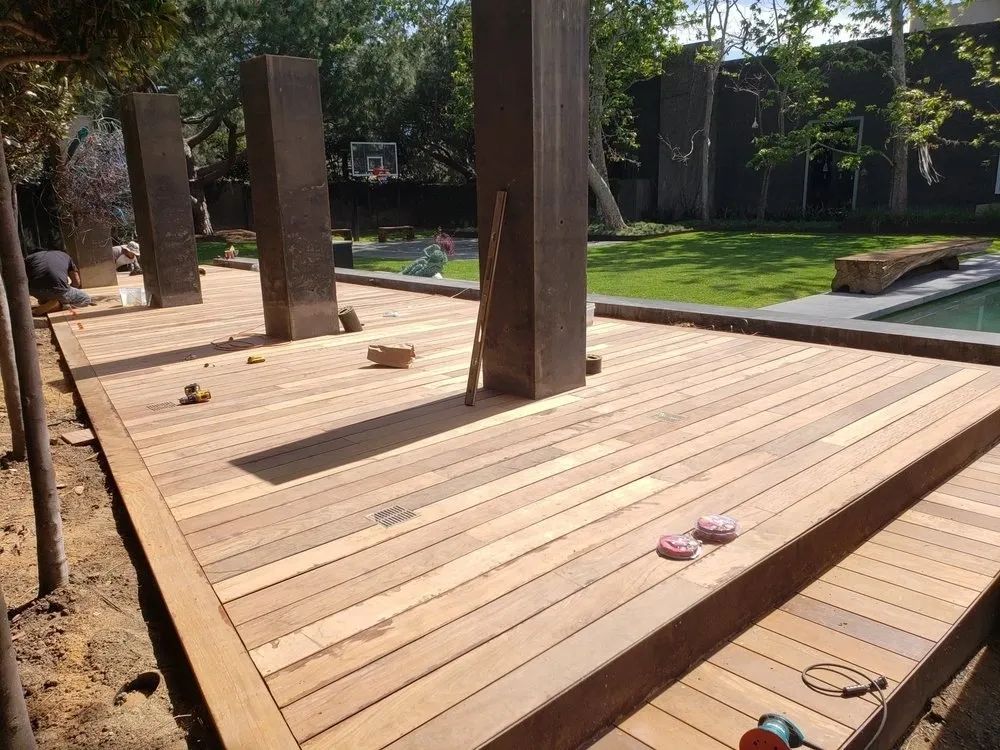 A wooden deck with a basketball hoop in the background