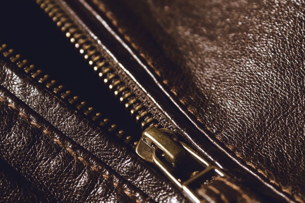 A Close Up Of A Zipper On A Brown Leather Jacket — Sew Affordable In Charmhaven, NSW