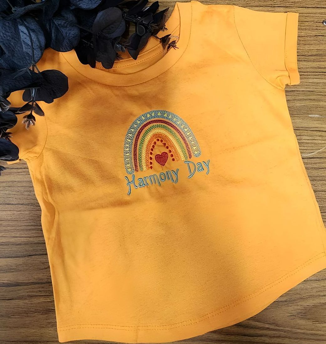 A Yellow T-shirt With A Rainbow Embroidered On It — Sew Affordable In Charmhaven, NSW