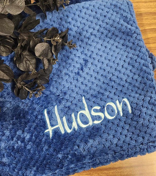 A Blue Blanket With The Name Hudson Embroidered On It — Sew Affordable In Charmhaven, NSW