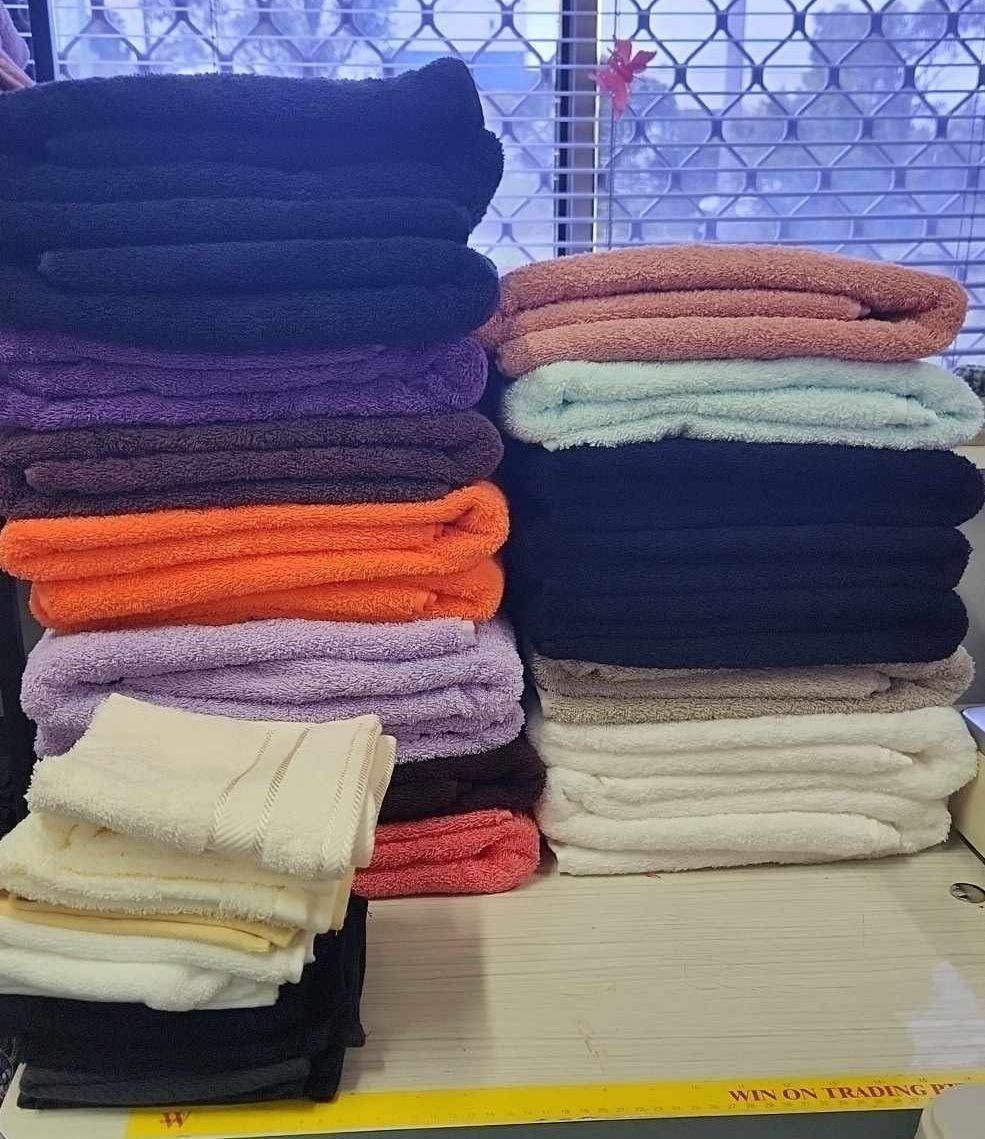 A Bunch Of Towels Are Stacked On Top Of Each Other — Sew Affordable In Charmhaven, NSW