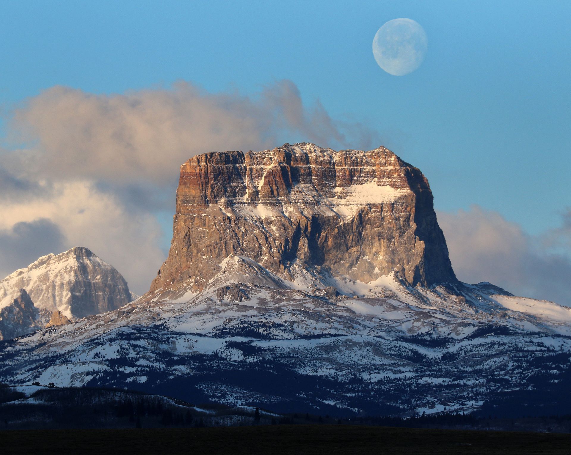 A sunset over a mountain range with a lot of fog