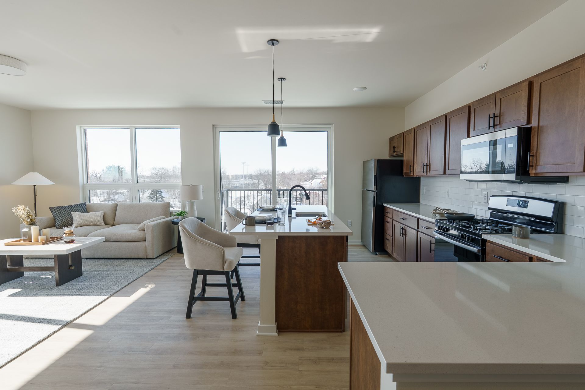 Photo of a large living room with an open floor plan and a kitchen integrated into the living room