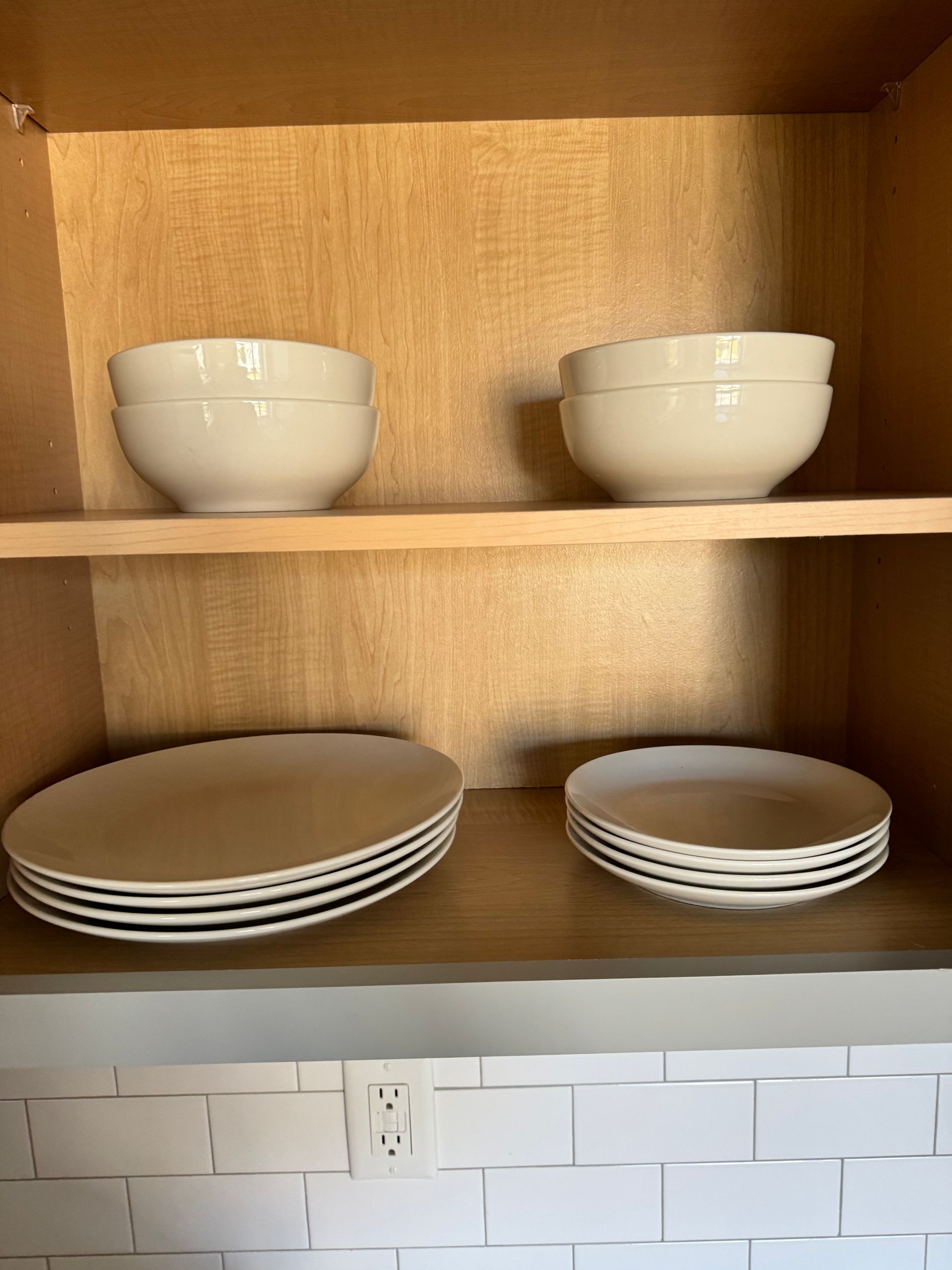 Photo of plates and bowls in a cabinet