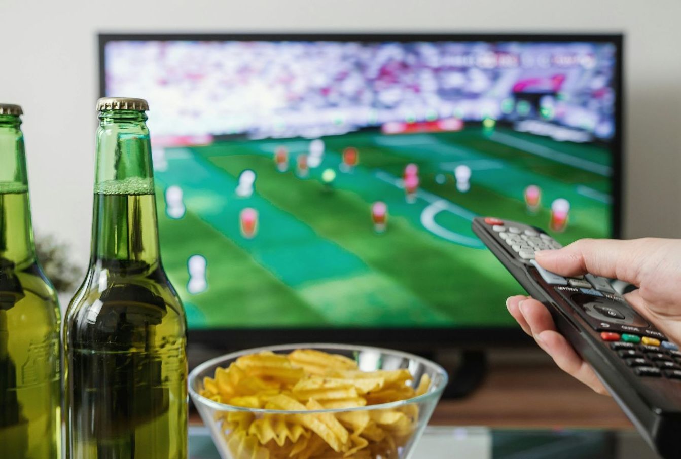 Photo of a remote being used and pointed at a television