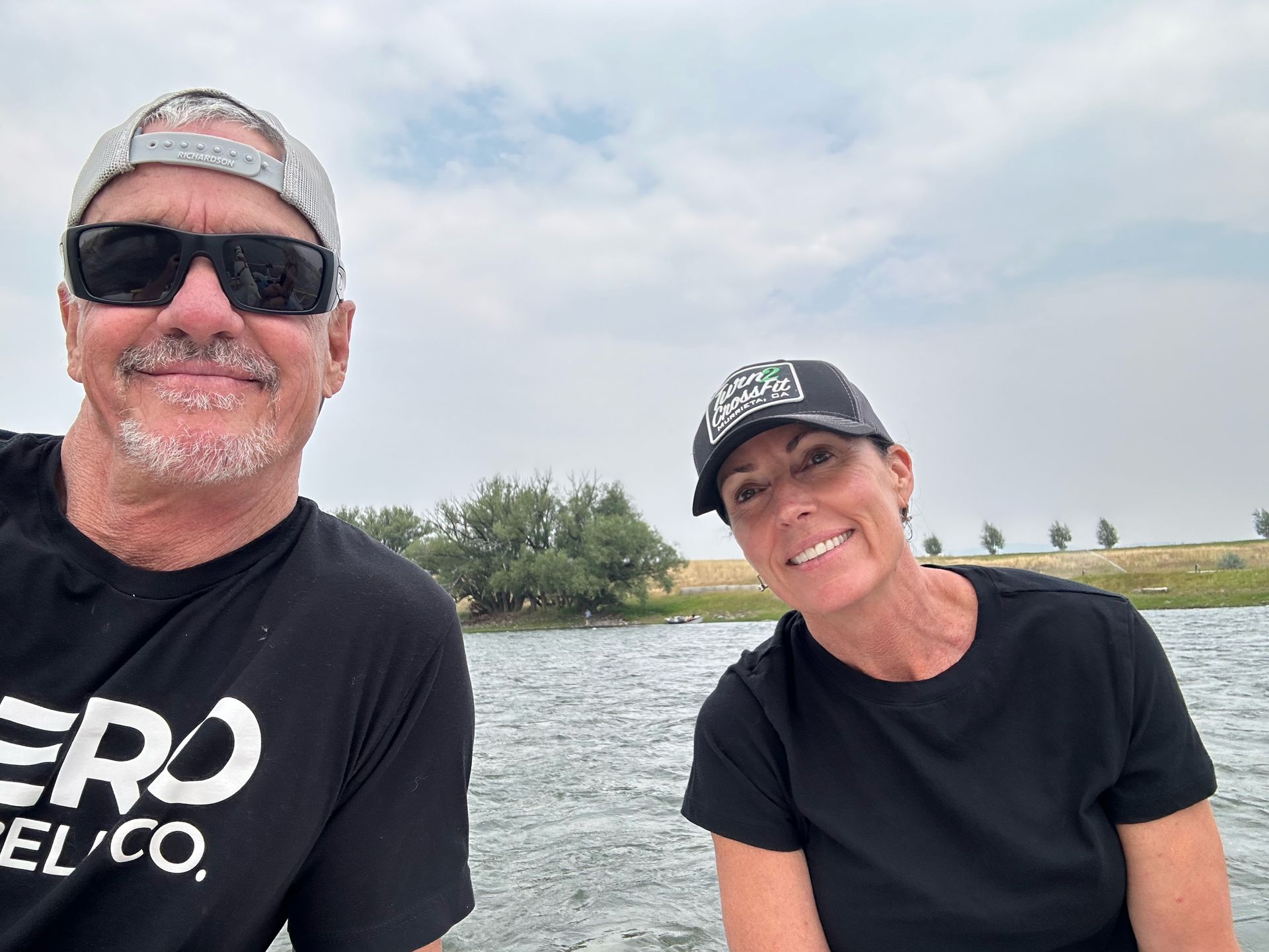 A man and a woman are sitting next to each other on a boat.