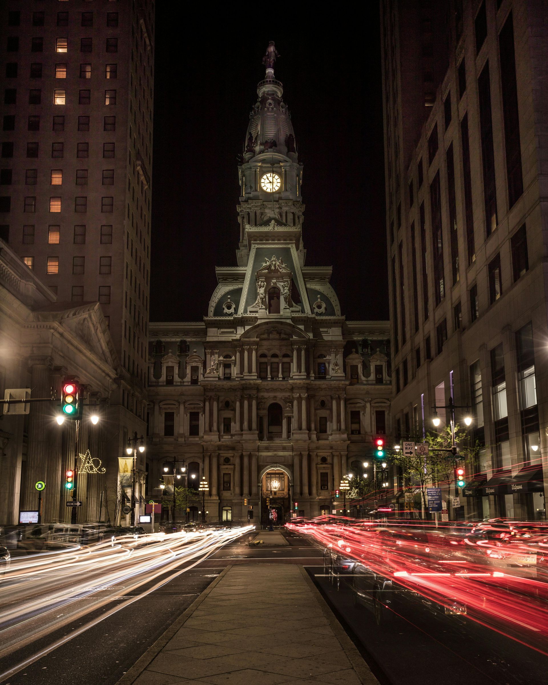 A large building with a clock tower is lit up at night