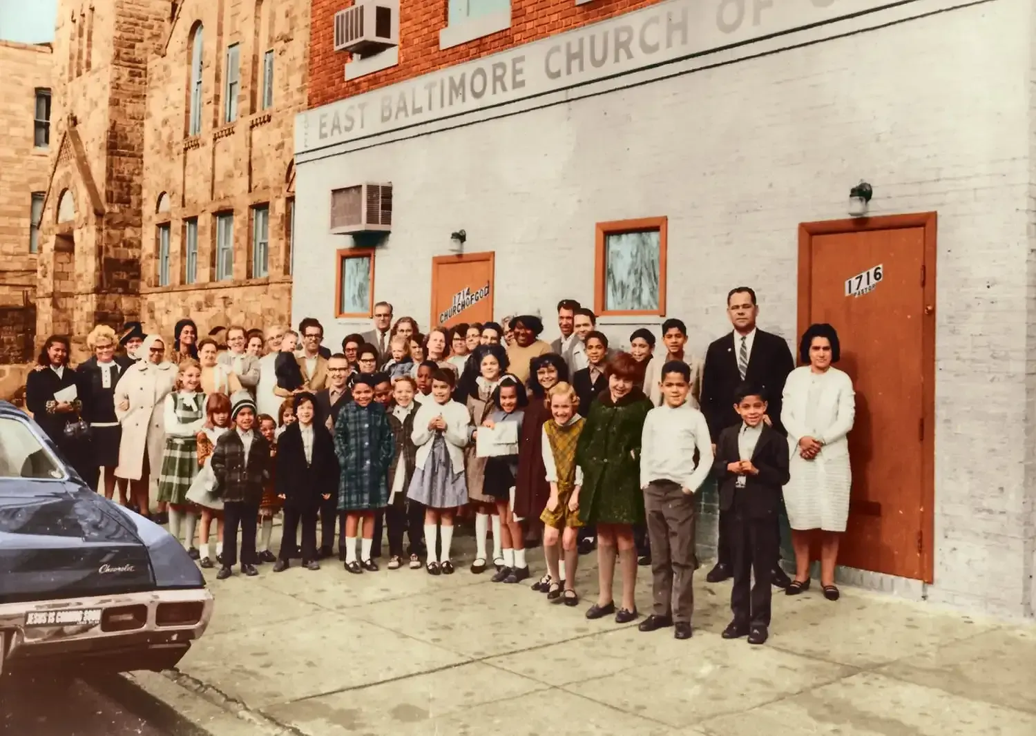 A group of people standing in front of the east baltimore church