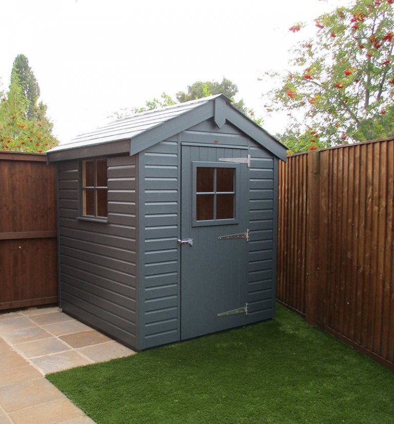 Blue shed in a garden in Preston, UK. Expertly painted by Rose Decor.