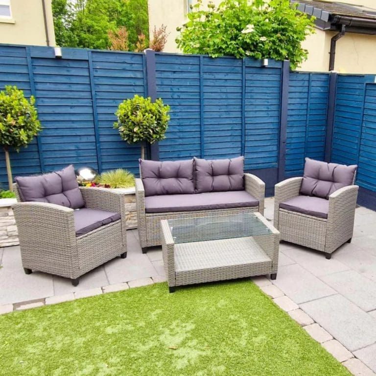 Painted blue fence with chairs in backyard