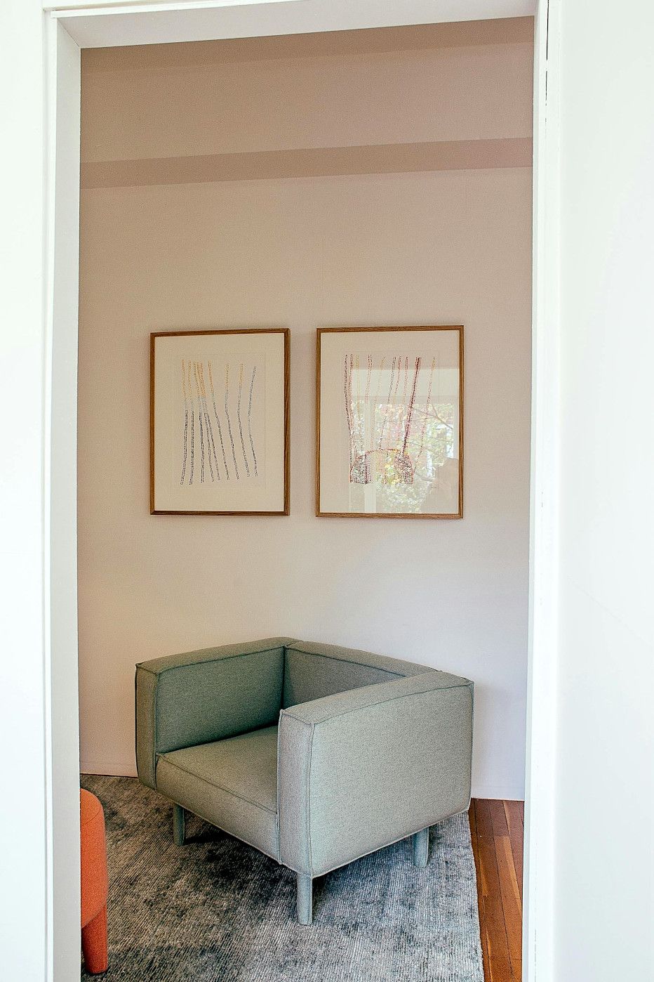 A bedroom with a bed , nightstands , a rug and a painting on the wall.