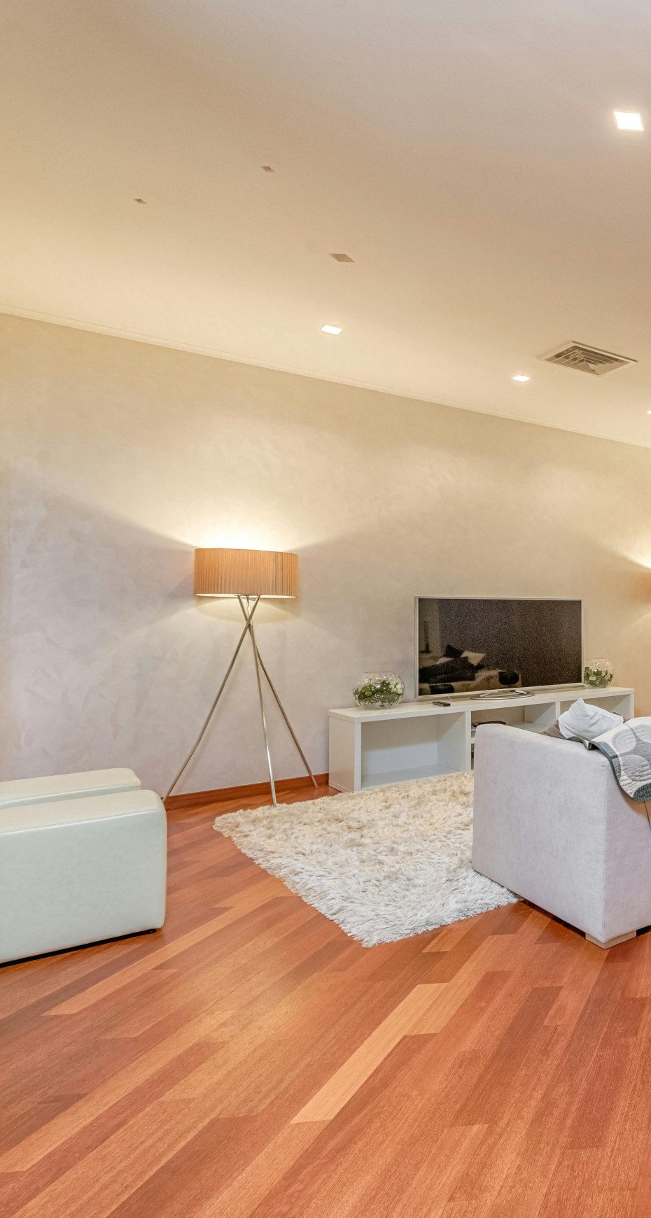 A bedroom with a bed , nightstands , a rug and a painting on the wall.