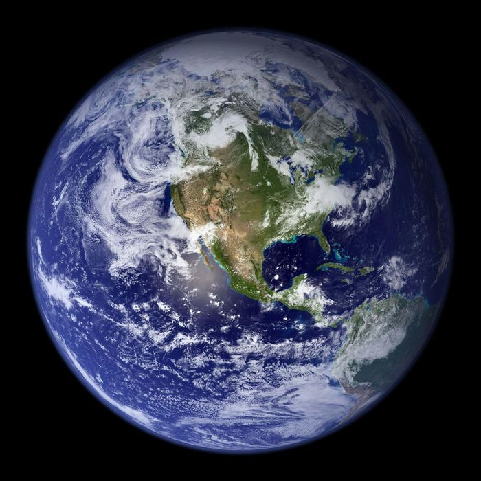 Earth from space, North America centered, blue oceans, green landmasses, white clouds, dark background.
