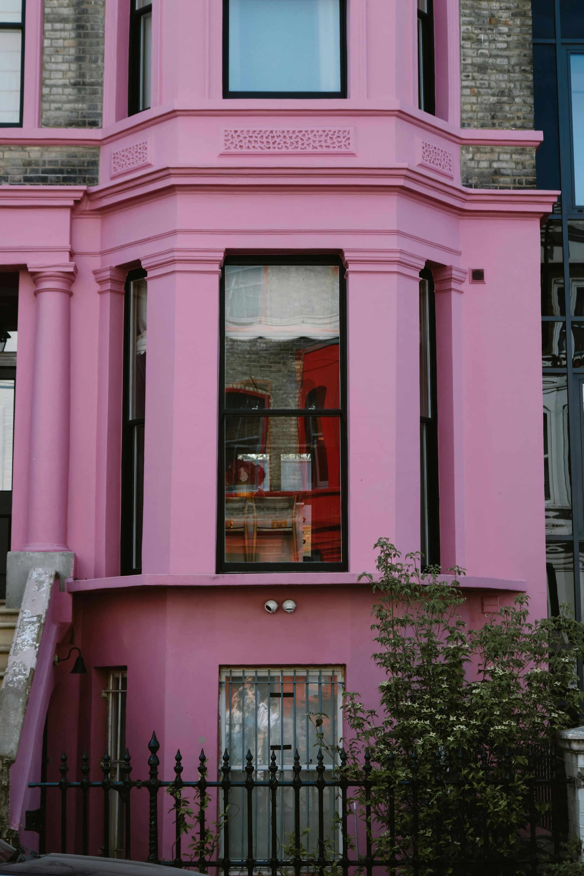 Pink exterior of a terraced apartment building in Preston, UK. Expertly painted by Rose Decor.