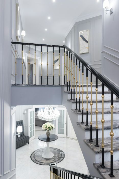 A staircase leading up to the second floor of a grand house. Staircase expertly painted by Rose Decor in Preston, UK.