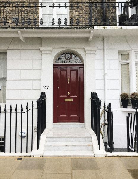 A red front door with the number 27 on it. Expertly painted by Rose Decor in Preston, UK.