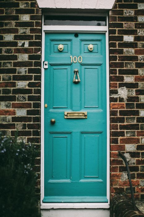 A blue door with the number 100 on it. Expertly painted by Rose Decor in Preston, UK.