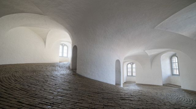 Church interior featuring domed ceiling and decorative lighting