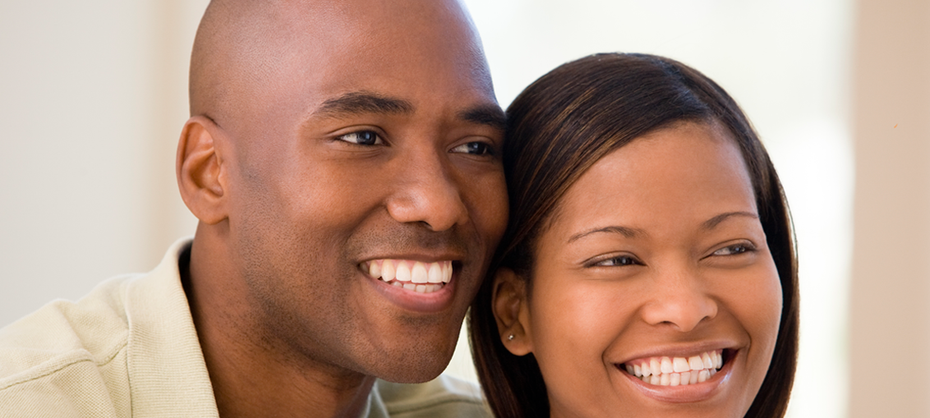 Smiling couple looking to the side.