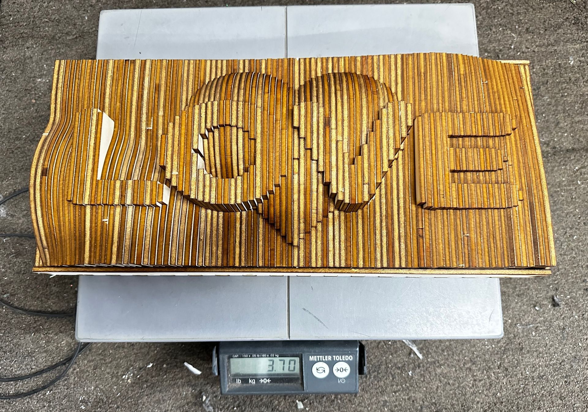 A piece of wood with the word love carved into it