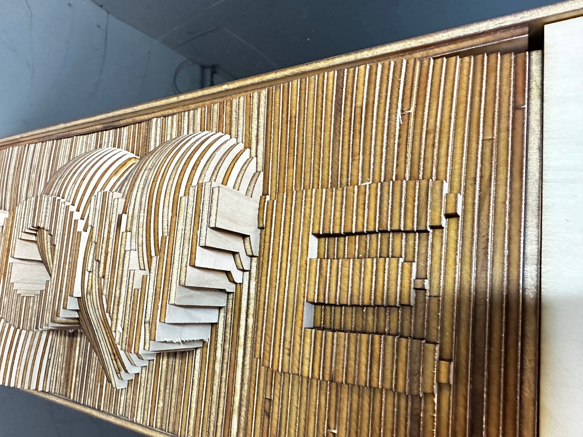 A wooden wall with a staircase made out of wooden sticks