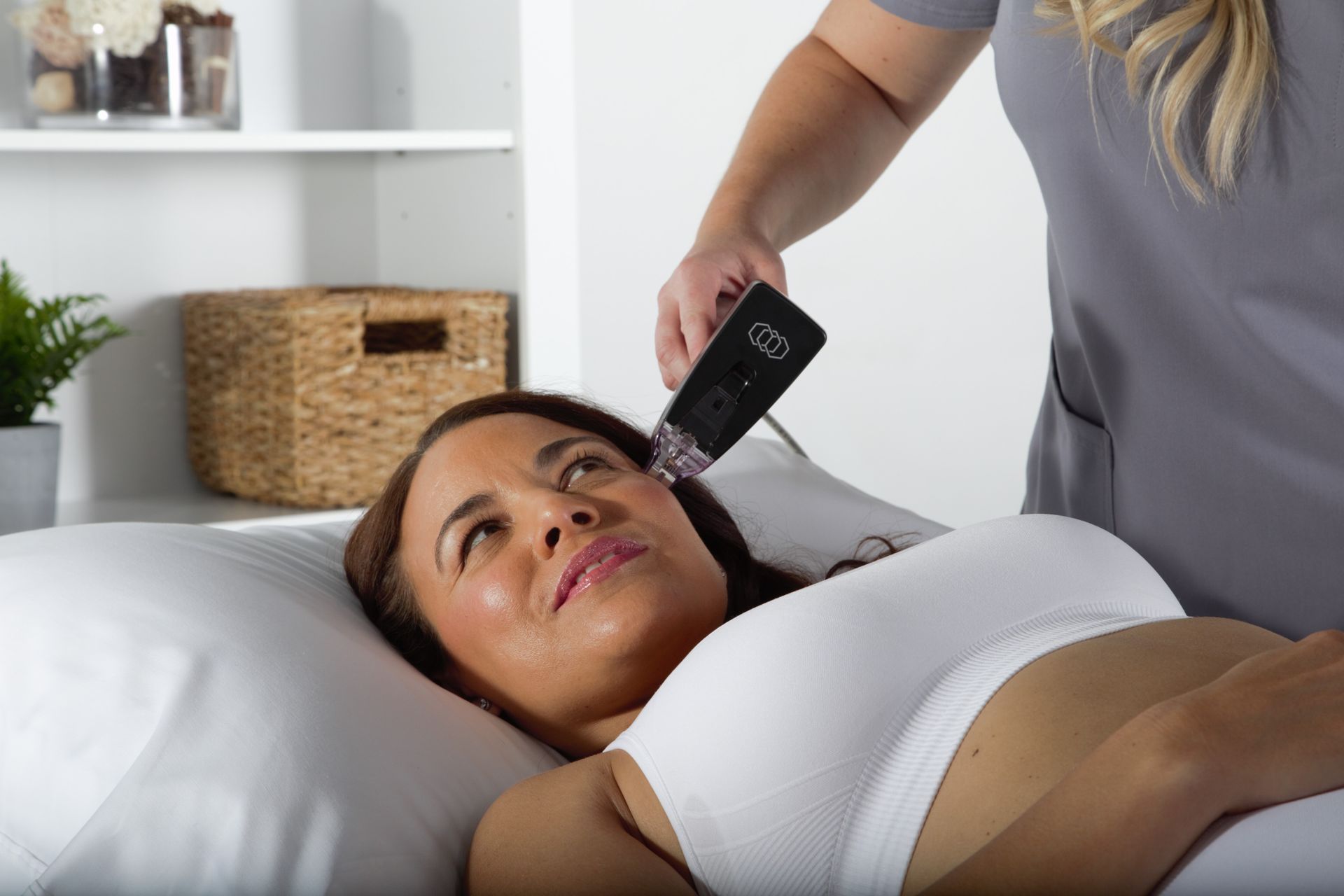 A woman is getting a skin treatment at a beauty salon.