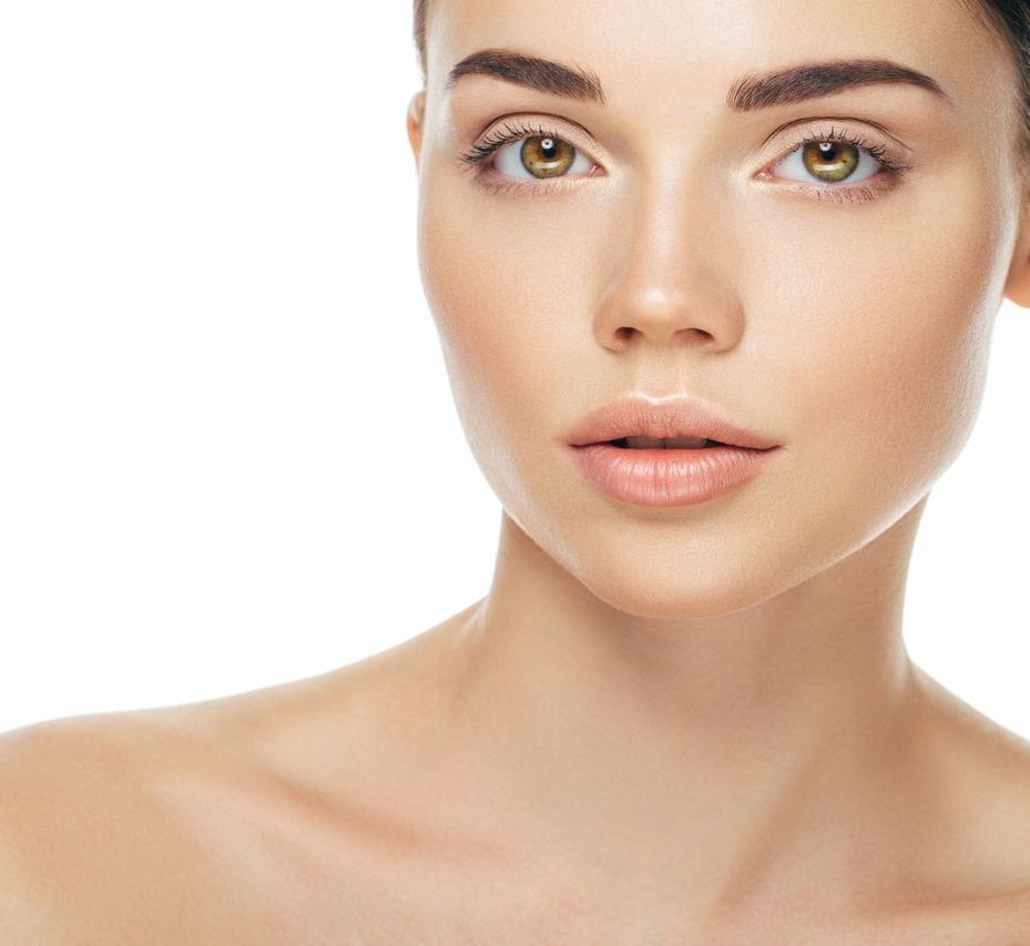A close up of a woman 's face with a white background