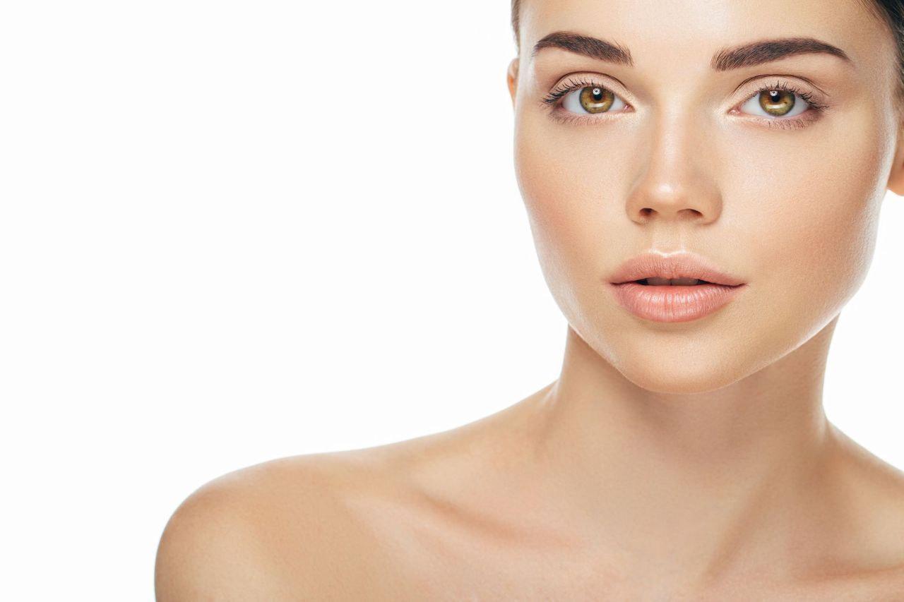 A close up of a woman 's face on a white background.