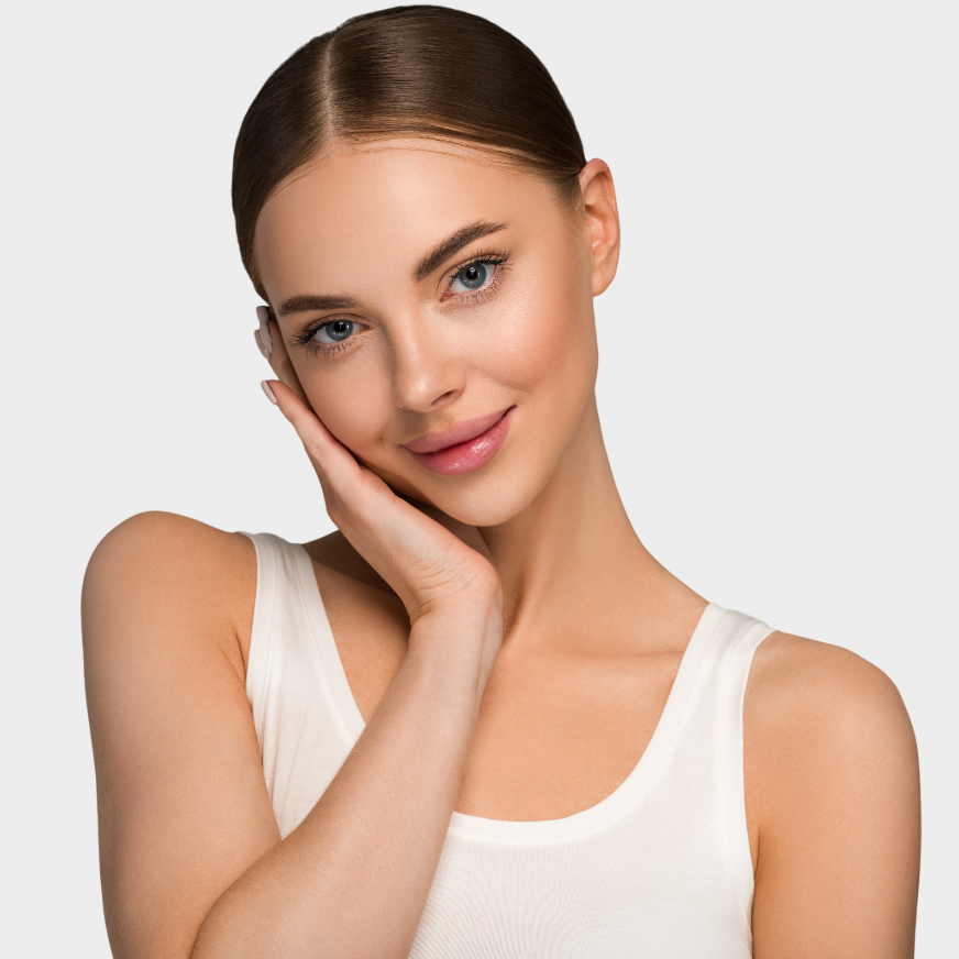 A woman in a white tank top is holding her hand to her face.