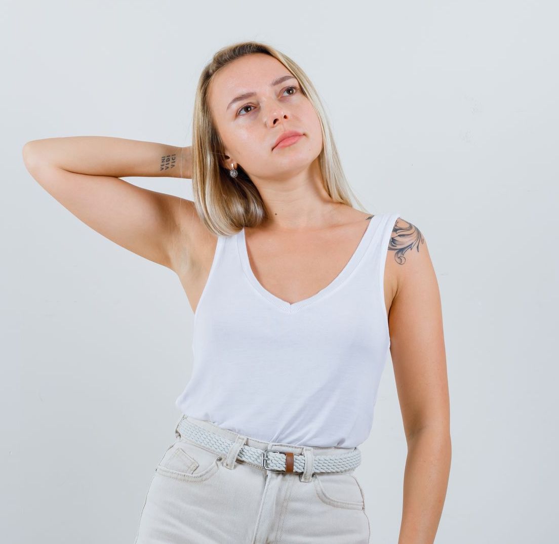 A woman with a faded tattoo on her wrist