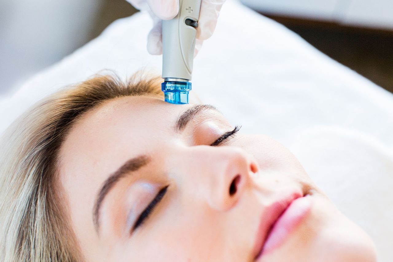 A woman is getting a facial treatment at a spa.