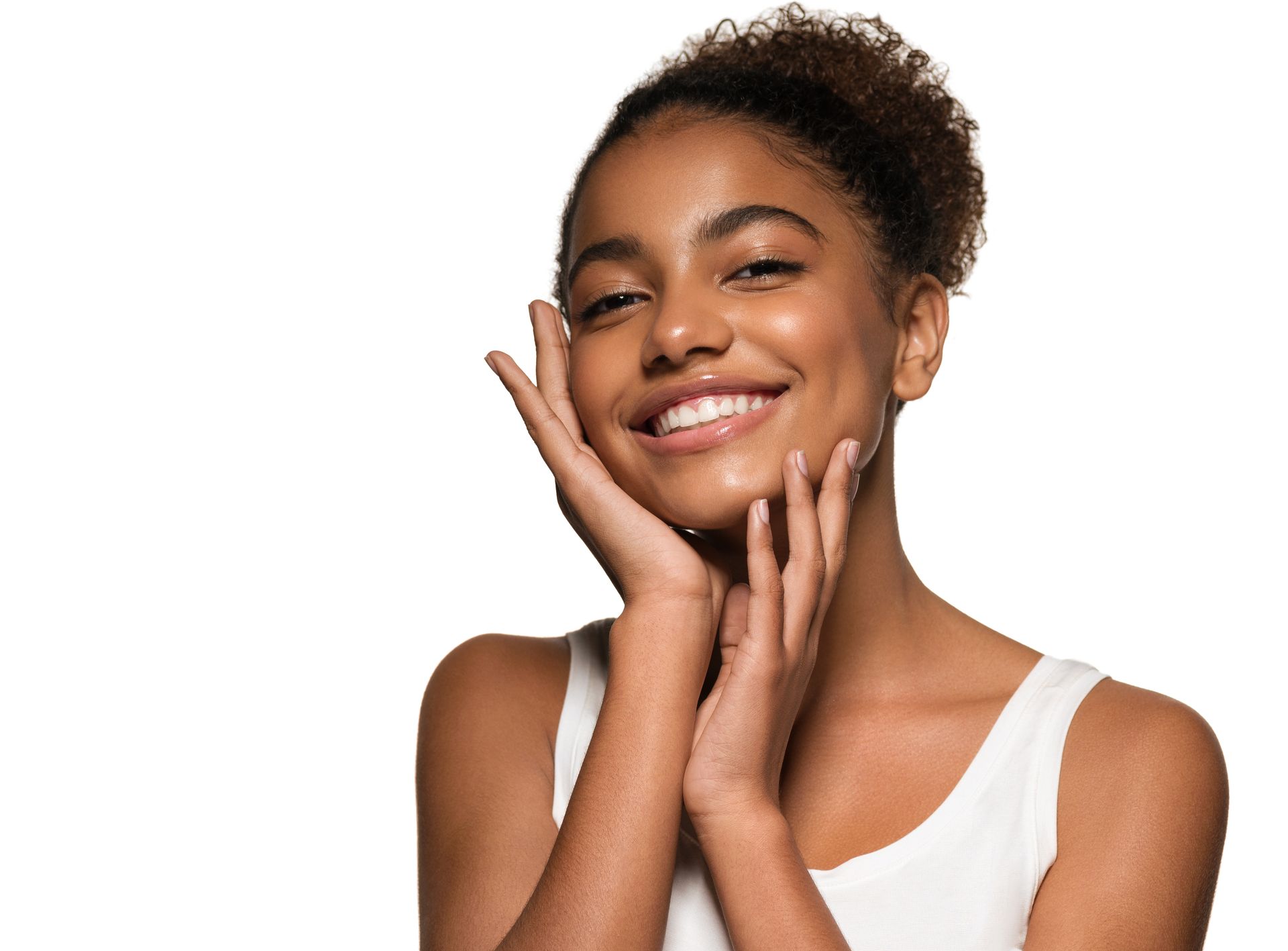 A woman is smiling and touching her face with her hands.