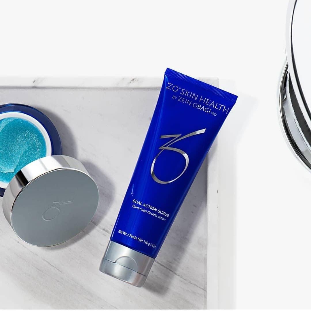A tube of zo skin health lotion is sitting on a table next to a mirror.