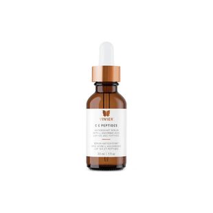 Amber dropper bottle with white label and copper cap on a white background