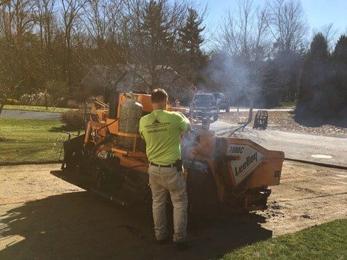 Road Roller — Worker Working on the Road Roller in Worcester, MA