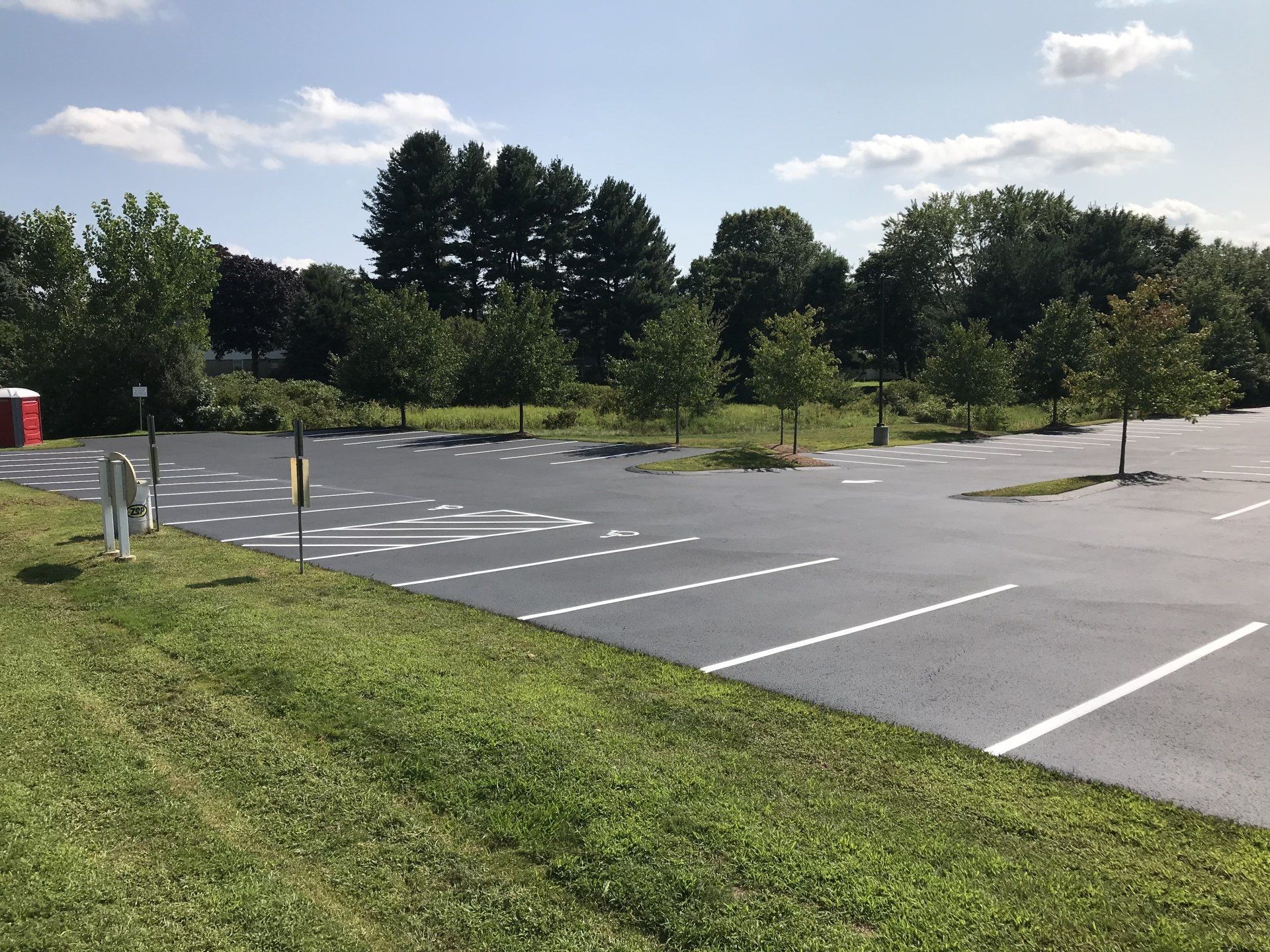 New Commercial Parking Lot — Parking Lot Beside a Green Field in Worcester, MA
