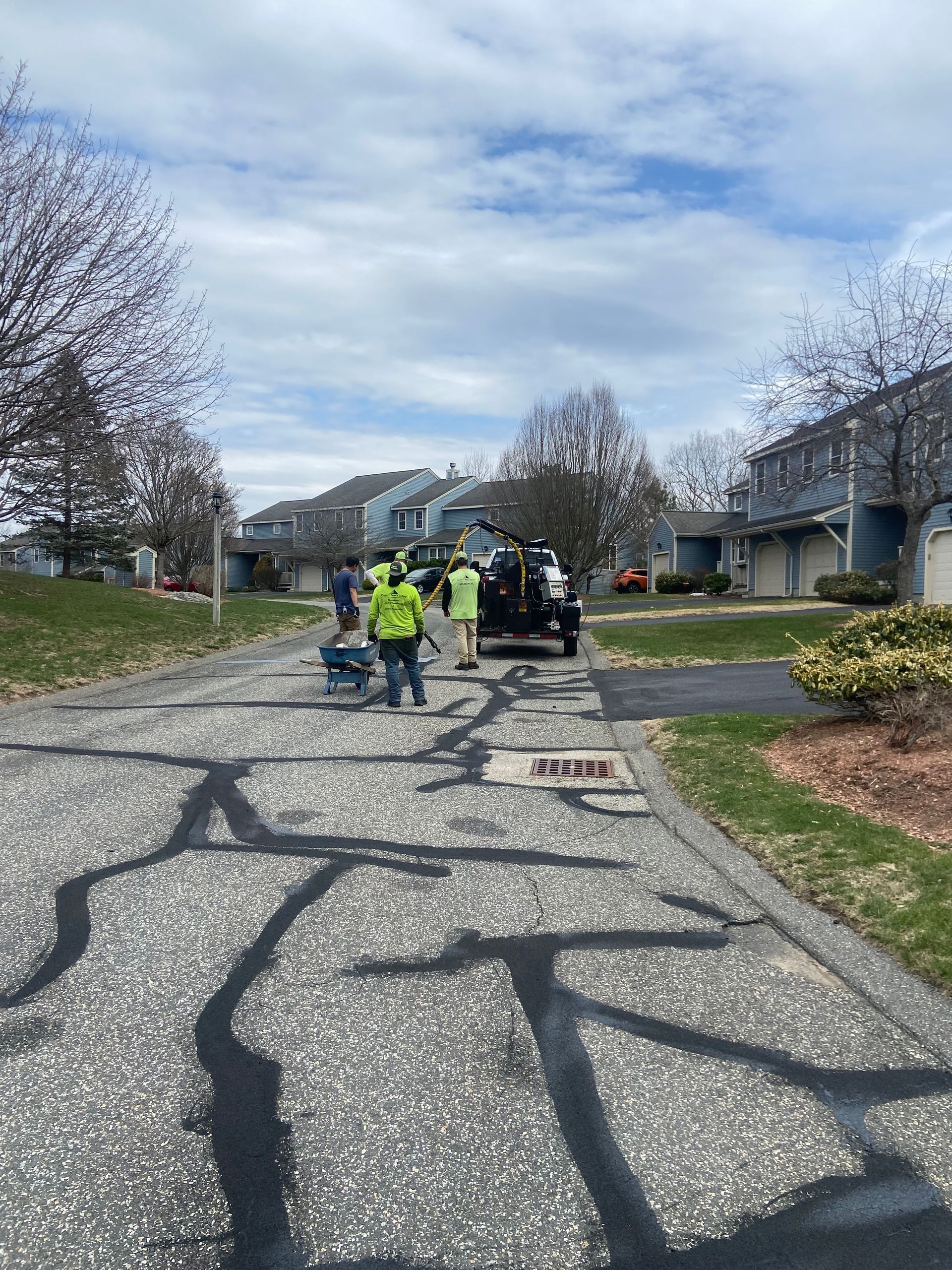 A group of people are standing in front of a white truck.