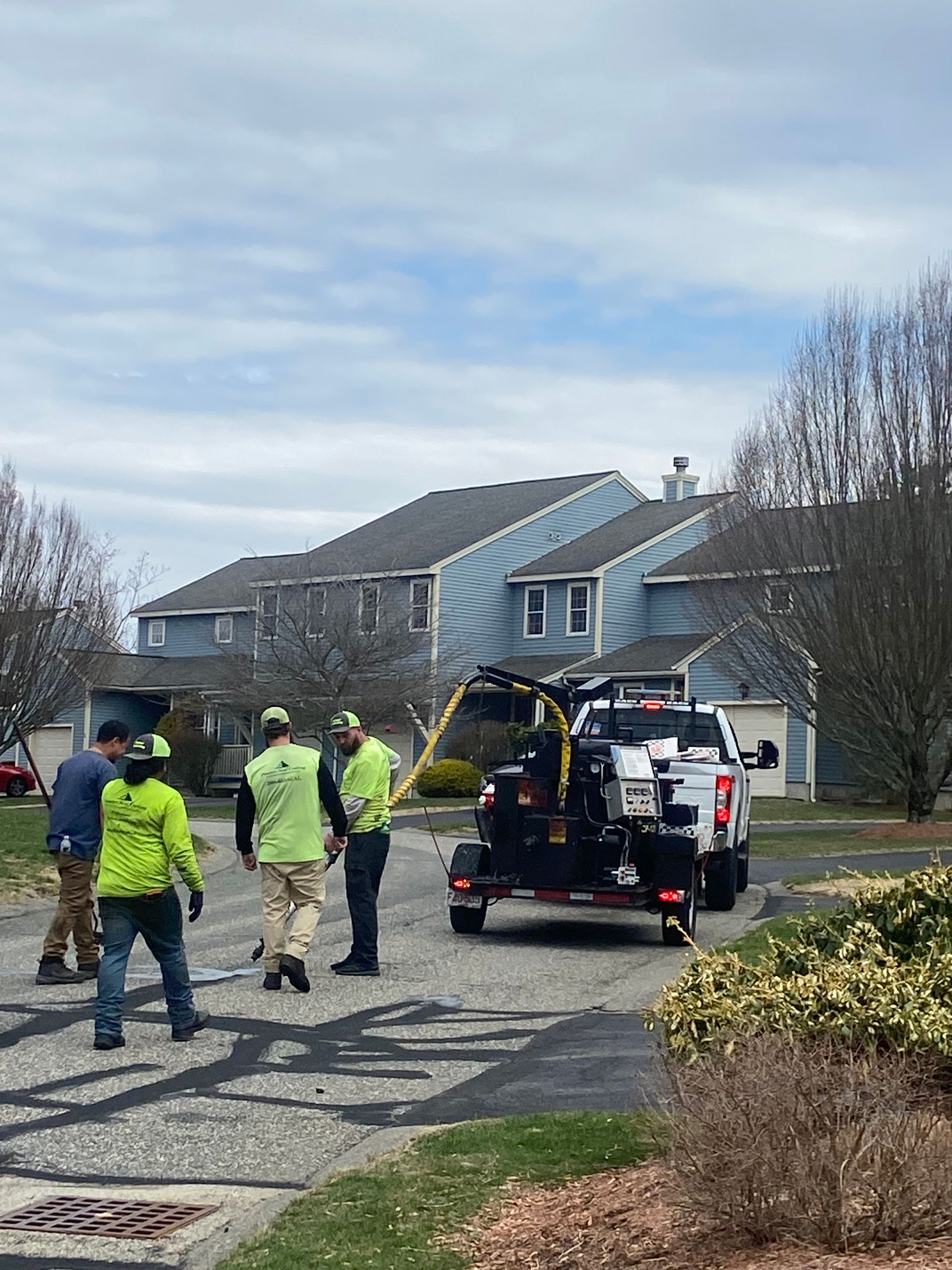 A group of people are standing in front of a white truck.